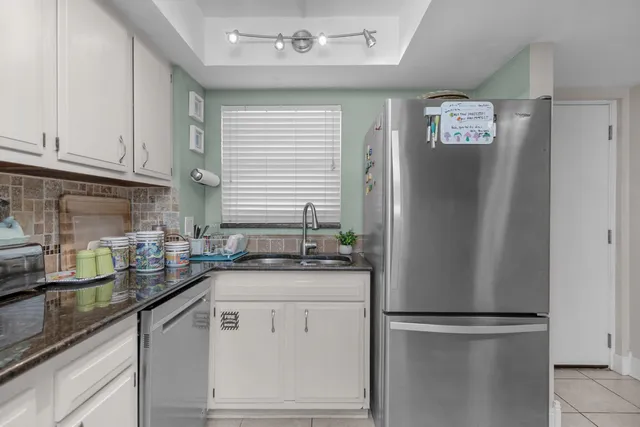 a kitchen with a refrigerator and a sink