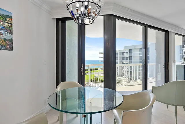 a dining room with furniture a chandelier and window