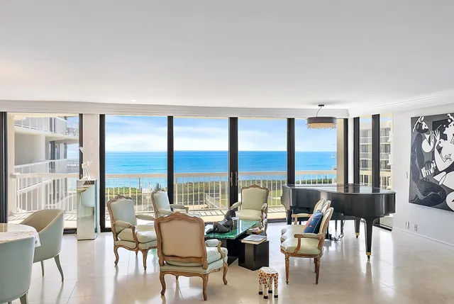 a view of living room with furniture and floor to ceiling windows