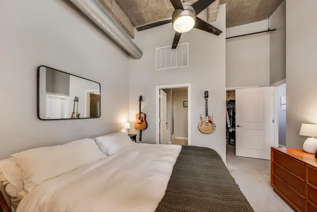 a bathroom with a granite countertop double vanity sink and mirror
