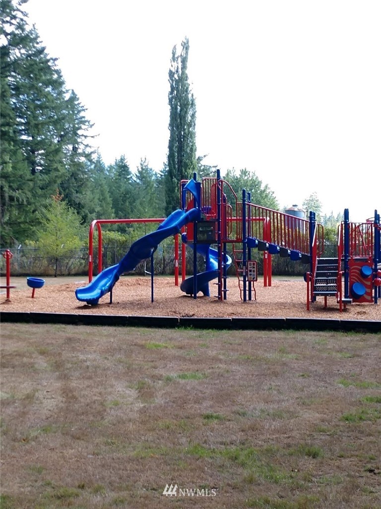 1032 Exit Road, Unit 32 Sumas, WA 98295 - Photo 11 of 12 a view of a park with large trees and couches