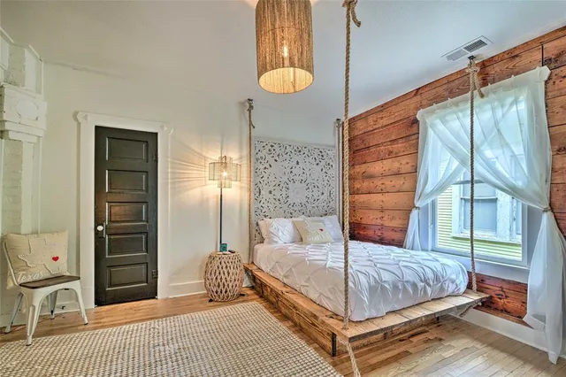 a bedroom with a bed and a window