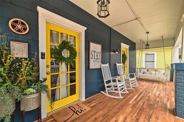 a view of a chairs and table in a balcony