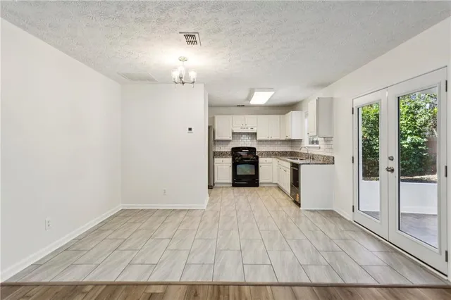 a view of kitchen with wooden floor electronic appliances and window