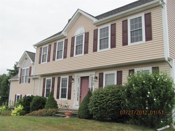 18 Winifreds Way Rutland, MA 01543 - Photo 1 of 13 a front view of a house with a yard and garage