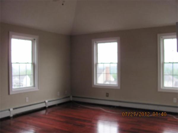 18 Winifreds Way Rutland, MA 01543 - Photo 7 of 13 an empty room with wooden floor and windows