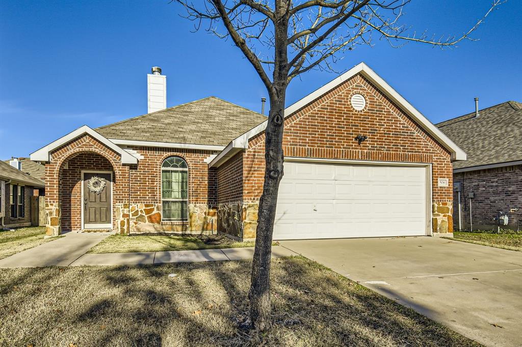 504 Thunder Trail Forney, TX 75126 - Photo 1 of 23 The property features a brick and stone exterior, an arched entryway, and an attached garage