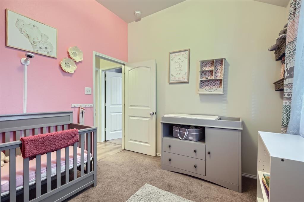 504 Thunder Trail Forney, TX 75126 - Photo 15 of 23 The room features a vaulted ceiling, carpeted flooring, and a white interior door with an arched panel design
