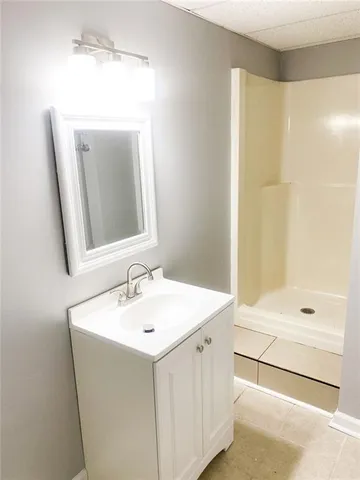 a bathroom with a sink a mirror and a shower