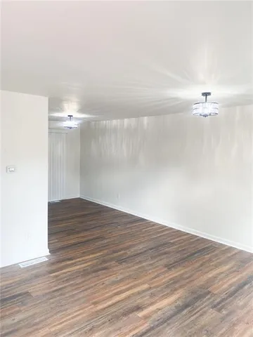 a view of a room with wooden floor