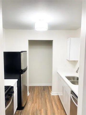 a kitchen with a sink and a refrigerator