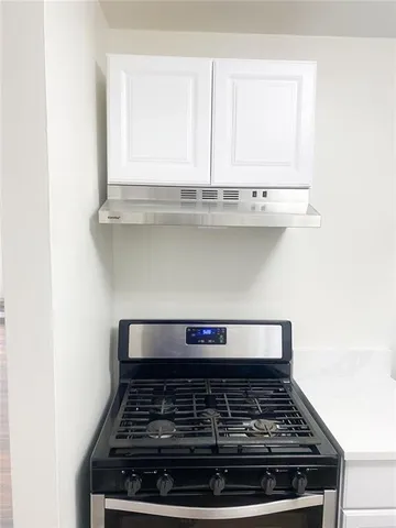a stove top oven sitting inside of a kitchen