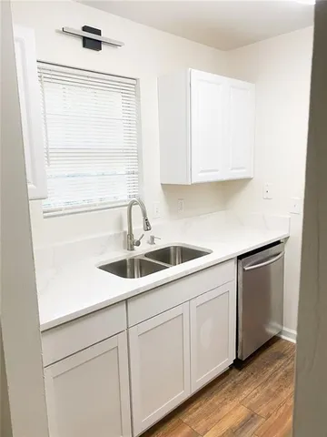 a kitchen with a sink and cabinets