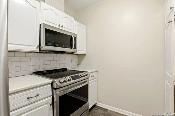 a kitchen with a stove and a microwave