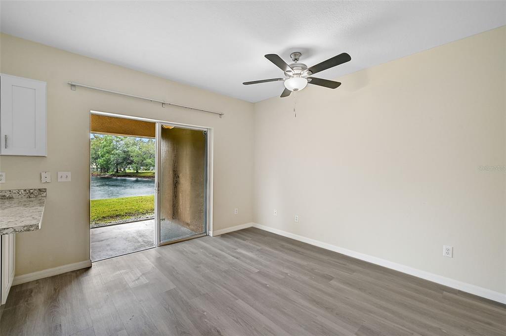 14939 Amberjack Terrace, Unit 102 Lakewood Ranch, FL 34202 - Photo 12 of 34 a view of an empty room with wooden floor and a window