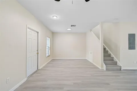 a view of an empty room with wooden floor