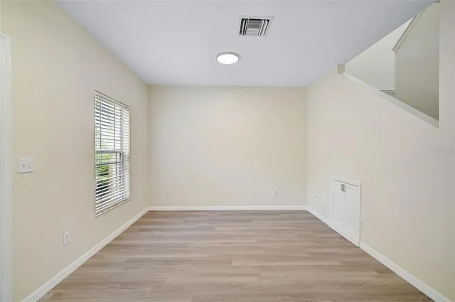 wooden floor in an empty room with a window