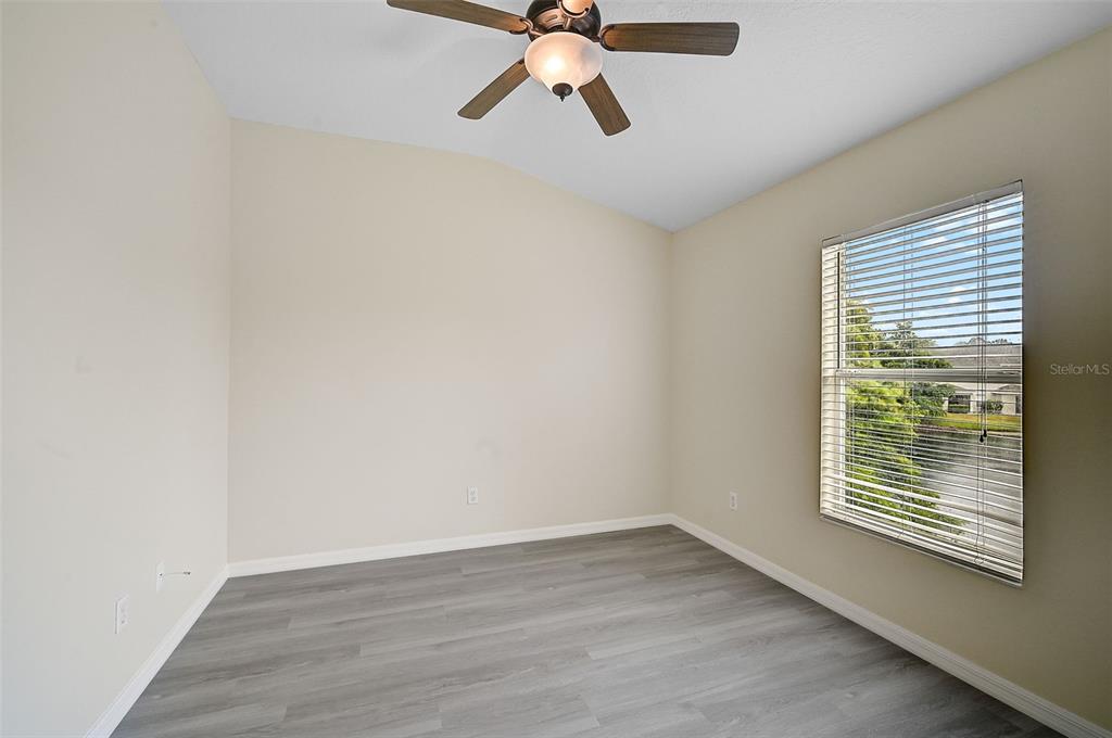 14939 Amberjack Terrace, Unit 102 Lakewood Ranch, FL 34202 - Photo 21 of 34 a view of an empty room with wooden floor and a window