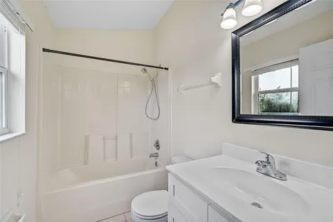 a bathroom with a sink toilet tub and shower