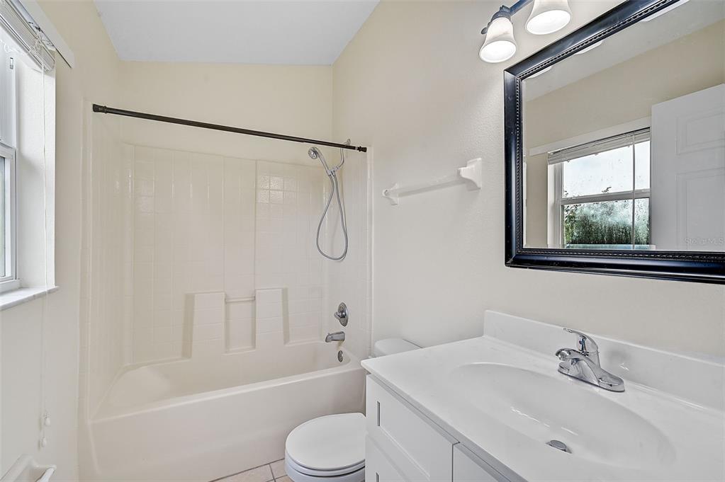 14939 Amberjack Terrace, Unit 102 Lakewood Ranch, FL 34202 - Photo 24 of 34 a bathroom with a sink toilet tub and shower