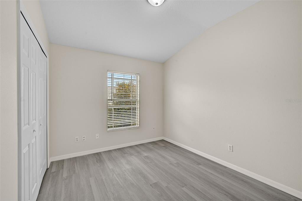 14939 Amberjack Terrace, Unit 102 Lakewood Ranch, FL 34202 - Photo 26 of 34 a view of an empty room with wooden floor and a window