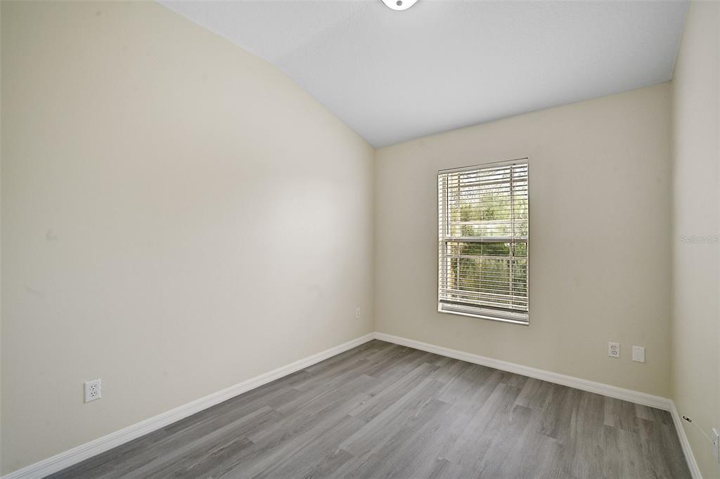 14939 Amberjack Terrace, Unit 102 Lakewood Ranch, FL 34202 - Photo 29 of 34 an empty room with wooden floor and windows