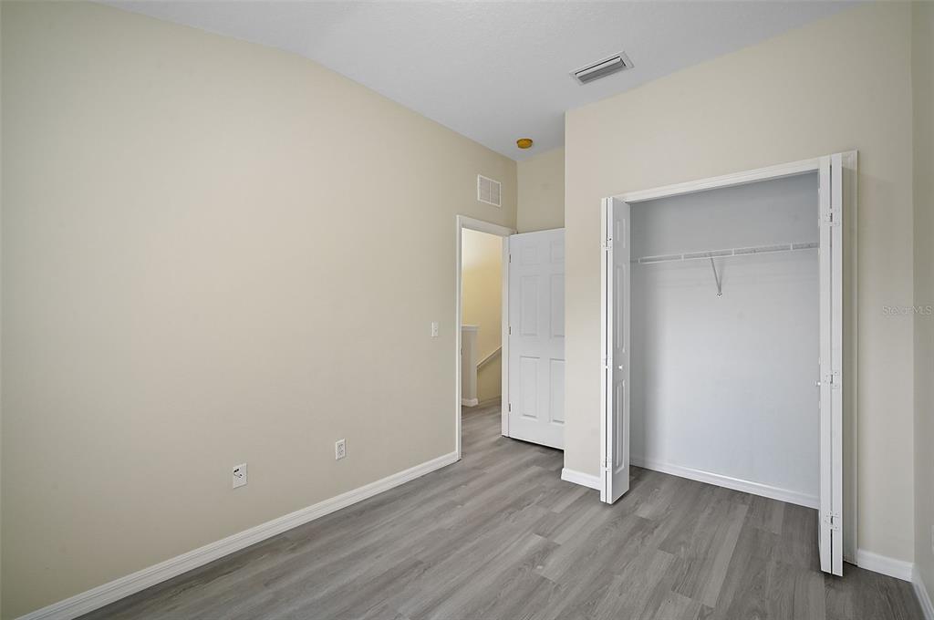 14939 Amberjack Terrace, Unit 102 Lakewood Ranch, FL 34202 - Photo 30 of 34 a view of an empty room with wooden floor and closet