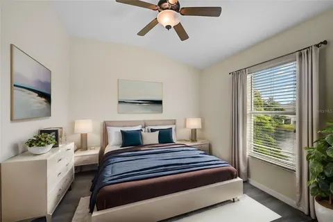 a bedroom with a bed and a chandelier