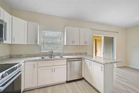 a kitchen with a sink stove and cabinets