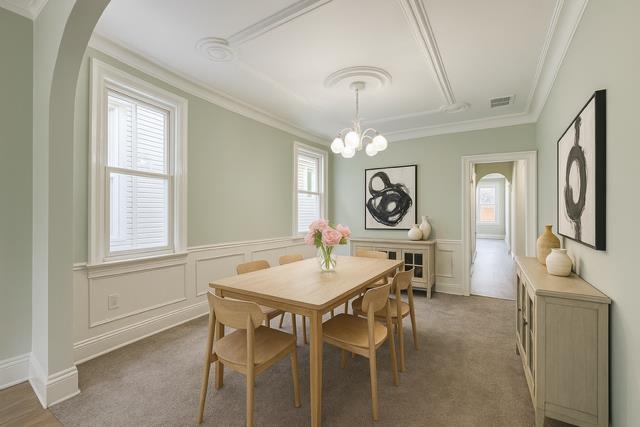 801 John F. Kennedy Boulevard, Unit 2 Bayonne, NJ 07002 - Photo 2 of 8 a view of a dining room with furniture window and wooden floor