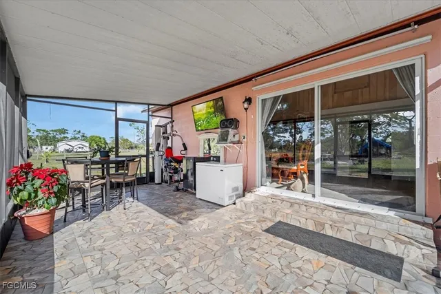 a view of a porch with dining table and chairs