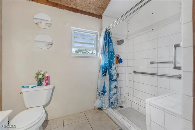 a white toilet sitting next to a bathroom sink