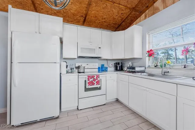 a kitchen with refrigerator and cabinets
