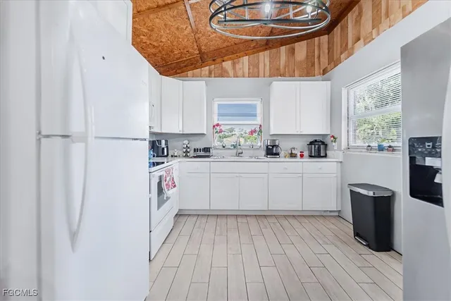 a kitchen with a sink window and cabinets