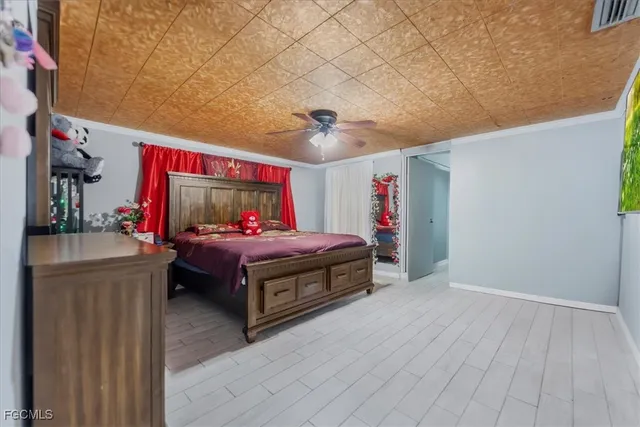 a spacious bedroom with a bed and a desk