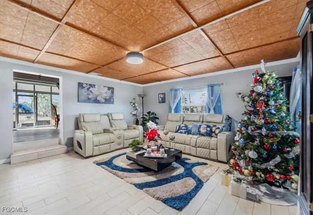 a living room with furniture and flowers