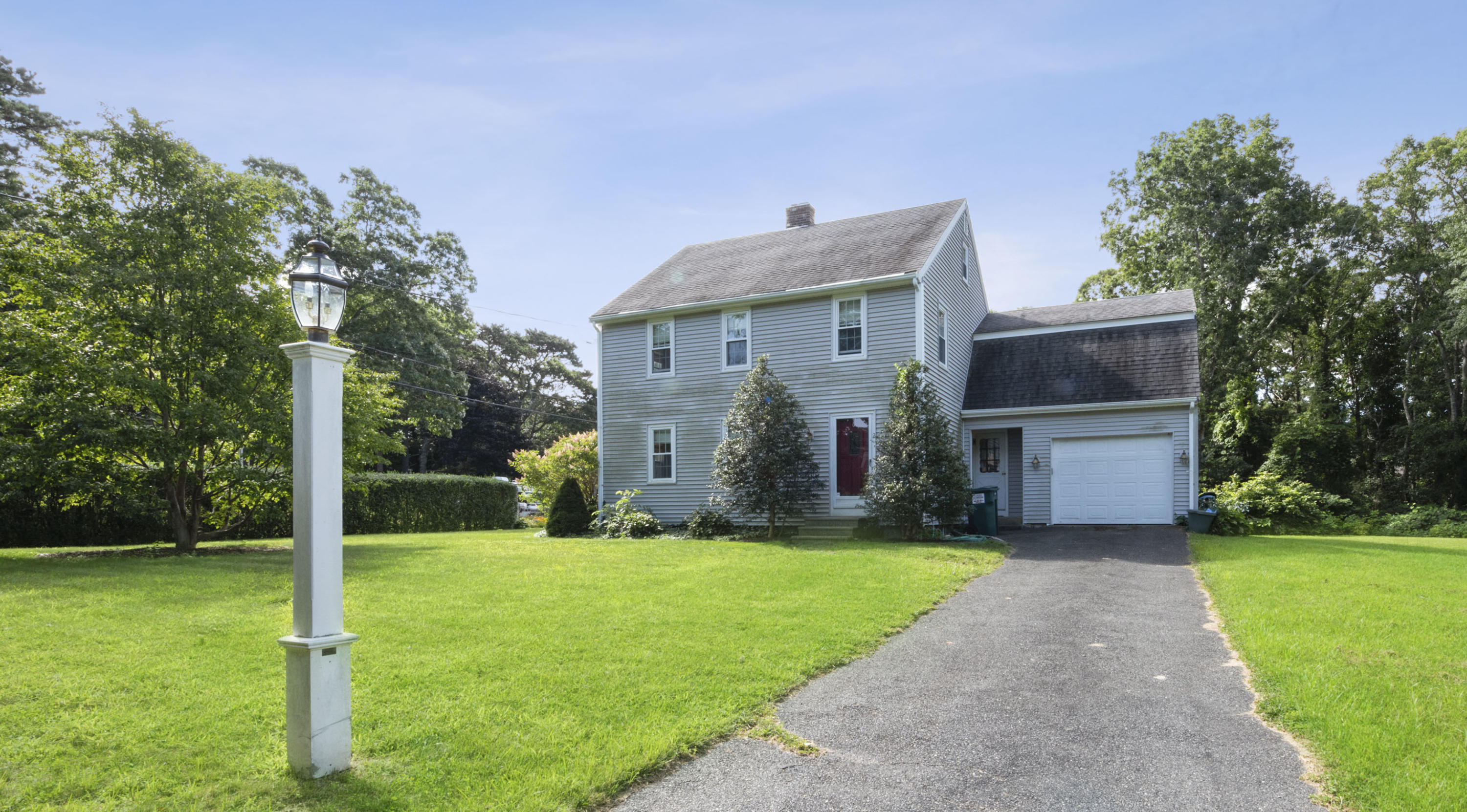 a view of a house with a yard and tree s