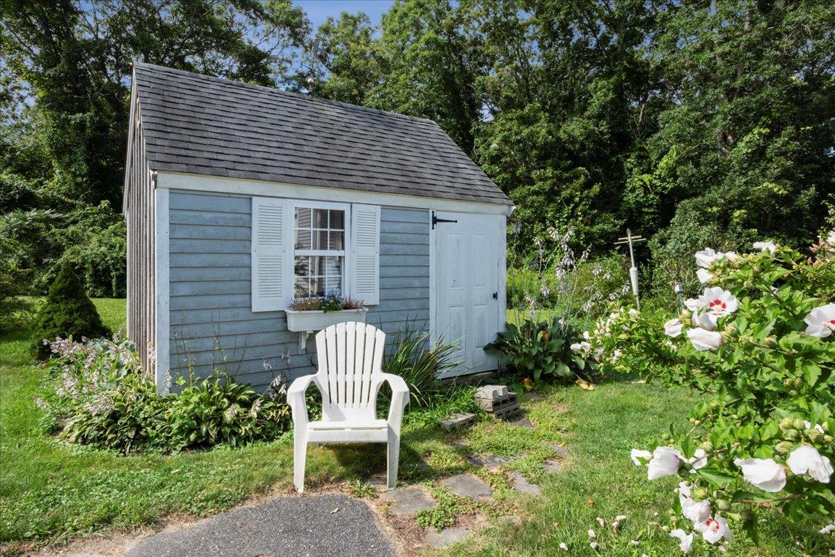 2 Crowell Road Sandwich, MA 02563 - Photo 20 of 34 a view of a chair and table in backyard of the house