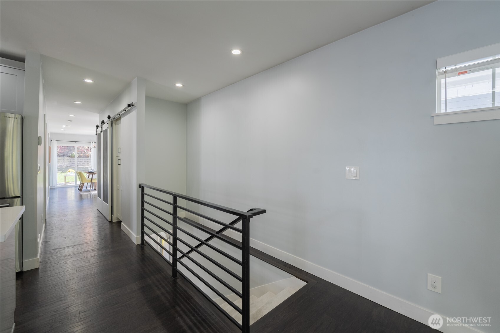 4418 40th Avenue Southwest Seattle, WA 98116 - Photo 27 of 40 a view of a hallway with wooden floor