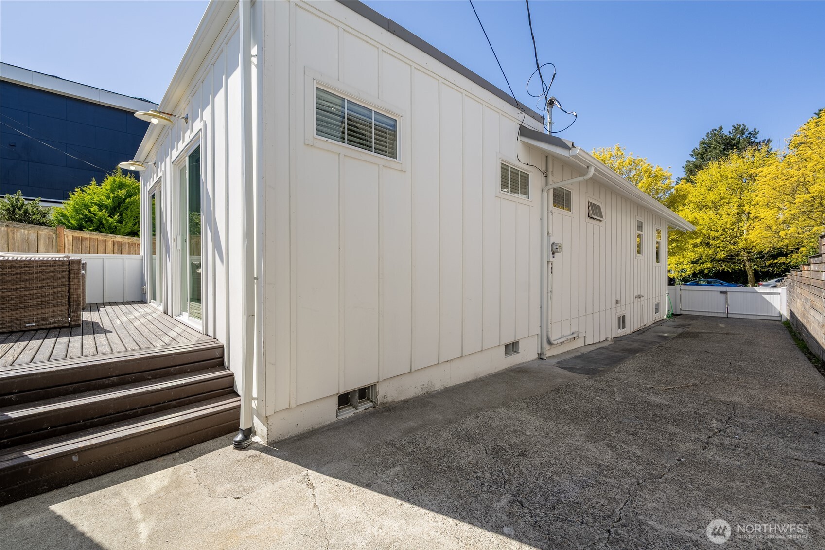 4418 40th Avenue Southwest Seattle, WA 98116 - Photo 37 of 40 a view of small house with wooden floor and a fence