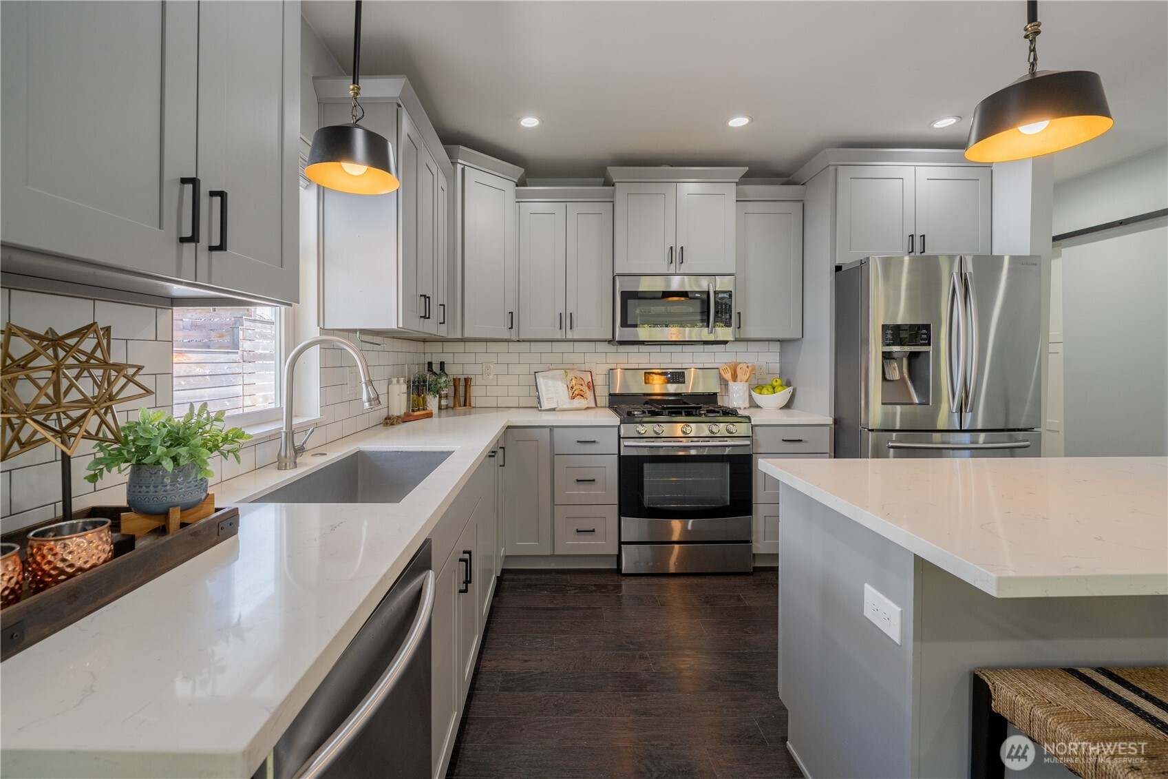 4418 40th Avenue Southwest Seattle, WA 98116 - Photo 5 of 40 a kitchen with kitchen island granite countertop a sink a counter space stainless steel appliances and cabinets