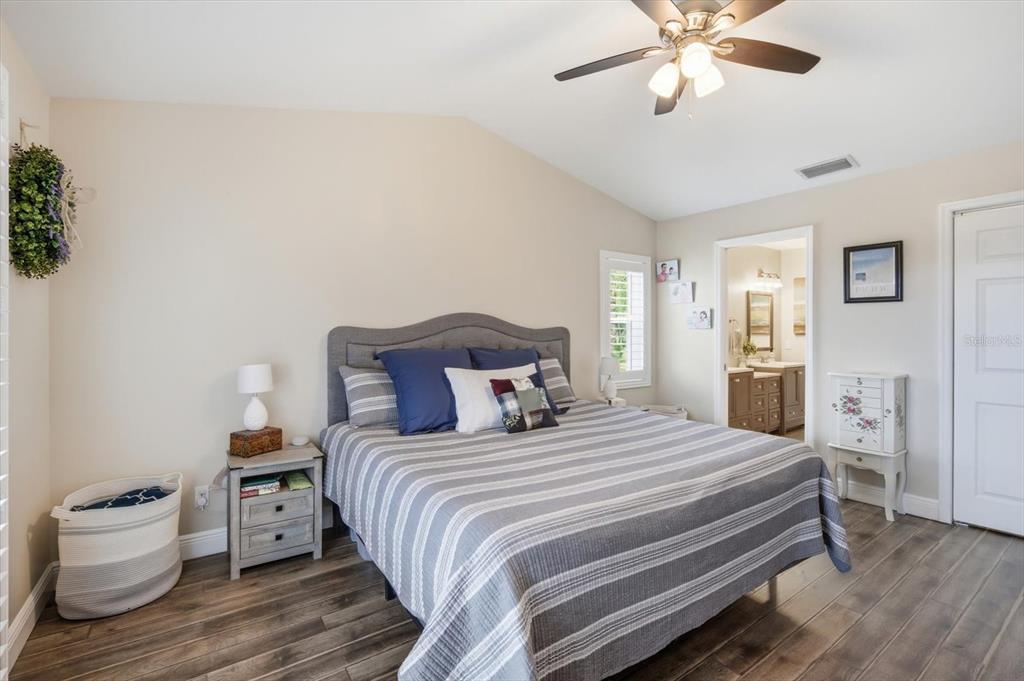 846 Birdie Way Apollo Beach, FL 33572 - Photo 14 of 31 a bedroom with a bed and wooden floor