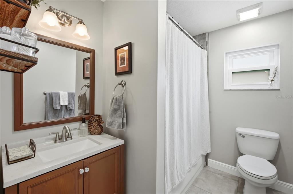 846 Birdie Way Apollo Beach, FL 33572 - Photo 25 of 31 a bathroom with a toilet sink and mirror