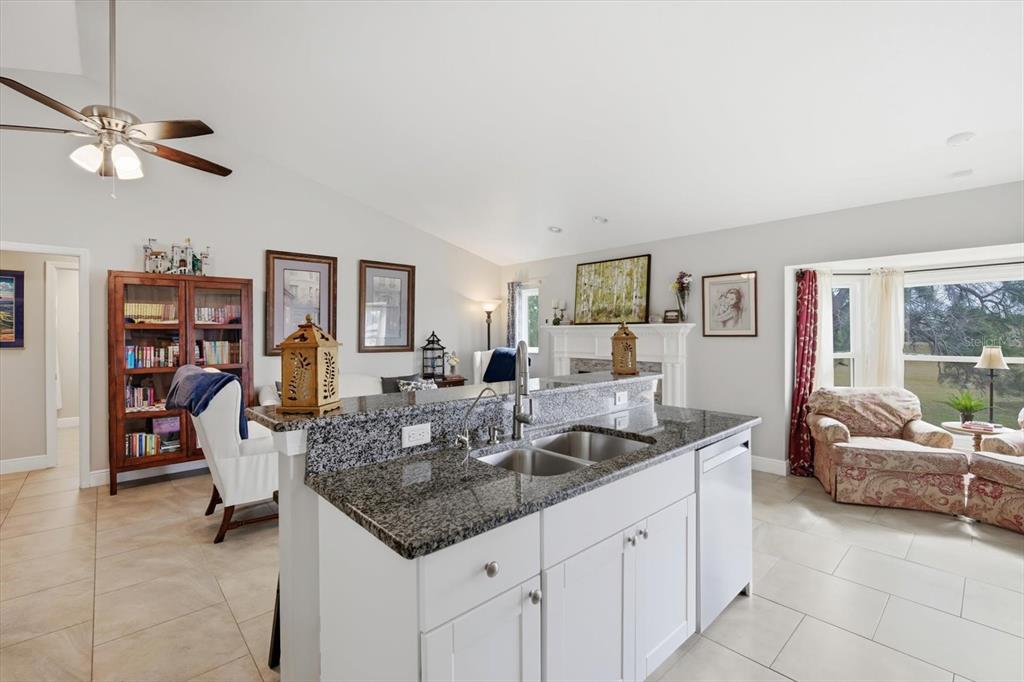 846 Birdie Way Apollo Beach, FL 33572 - Photo 7 of 31 a kitchen with granite countertop a table and chairs