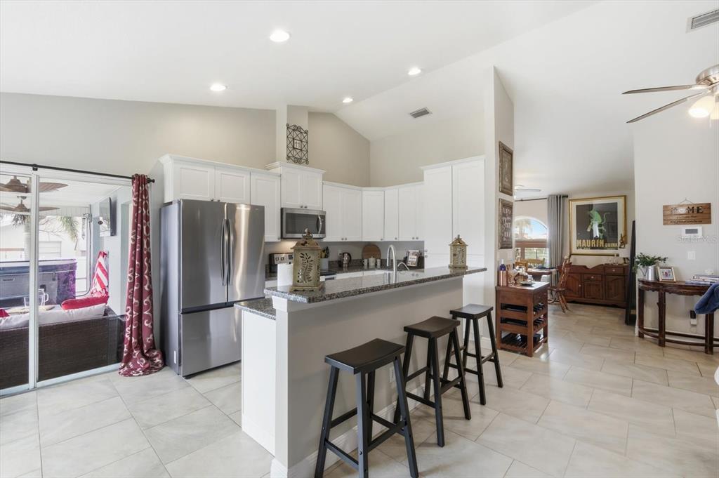 846 Birdie Way Apollo Beach, FL 33572 - Photo 8 of 31 a kitchen with stainless steel appliances granite countertop a refrigerator and a stove top oven