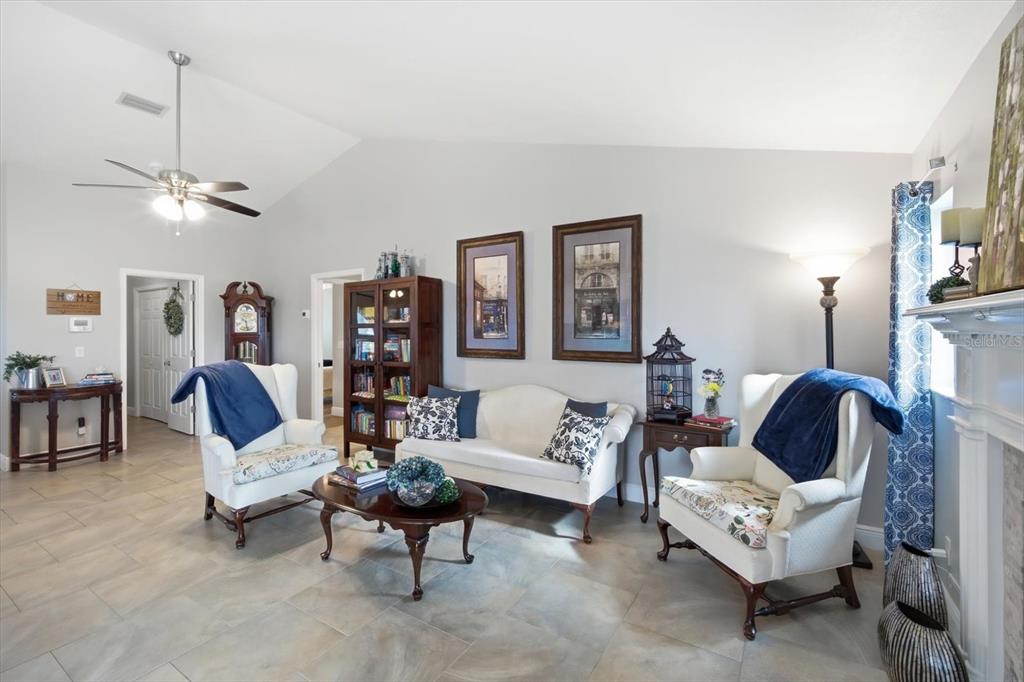 846 Birdie Way Apollo Beach, FL 33572 - Photo 9 of 31 a living room with furniture and a chandelier