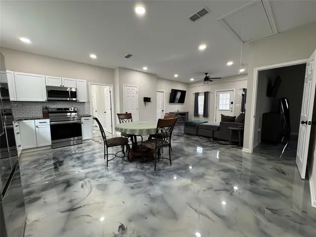 a large kitchen with stainless steel appliances lots of counter top space