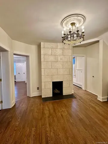 wooden floor with fireplace in living room