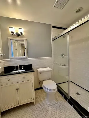 a bathroom with a sink a toilet and mirror
