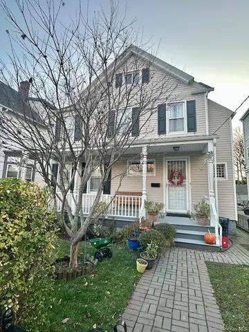 a front view of a house with a garden